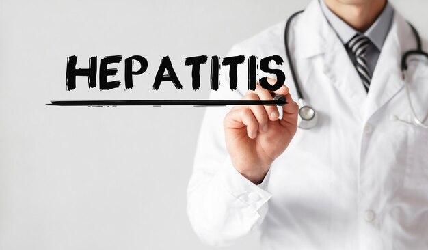 Photo doctor writing word hepatitis with marker, medical concept