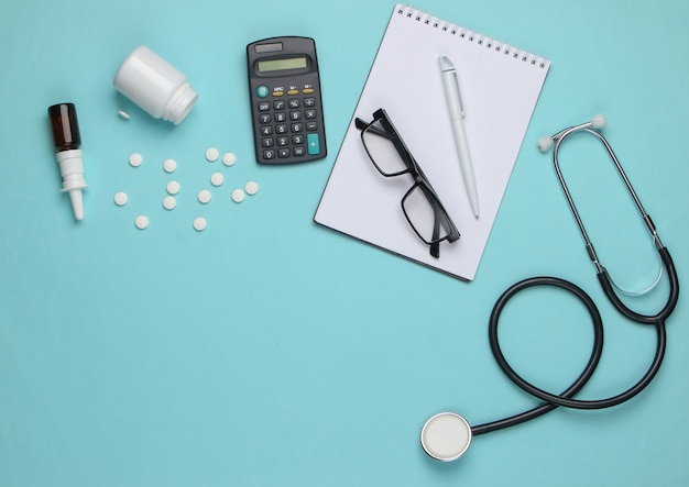 Doctoral supplies and tools, calculator on blue.