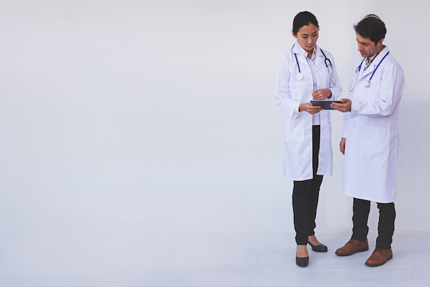 Doctors checking patient information on a tablet device