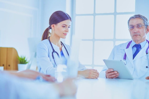 Doctors consulting with each other in a hospital conference room