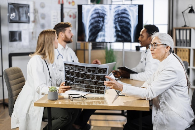 Photo doctors discussing lungs ct at modern hospital