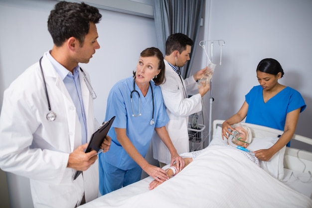 Doctors examining senior patient