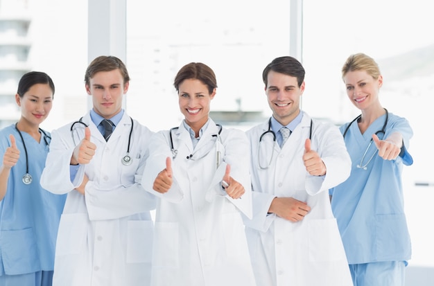 Doctors gesturing thumbs up at hospital