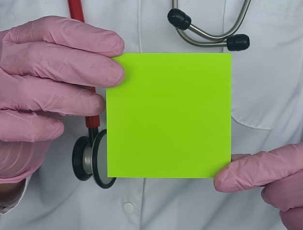 Doctors in glove hold a business card envelope with copy space