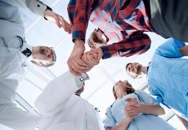 Doctors greet a colleague in a team with a handshake