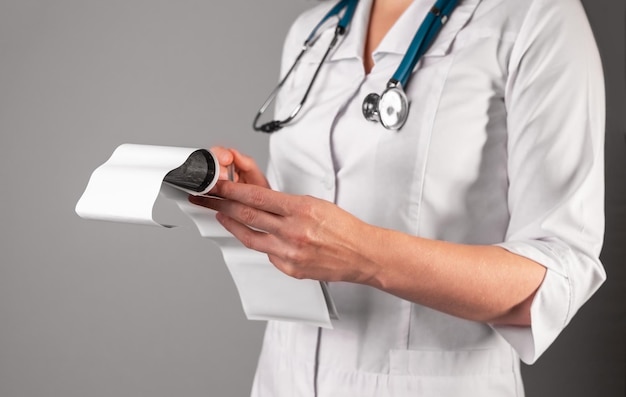 Doctors hand holding studying medical documents ultrasound scan