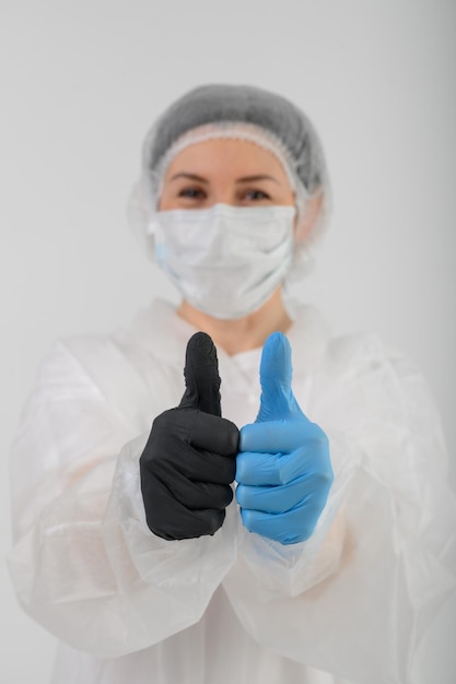 Doctors hands in blue and black rubber gloves