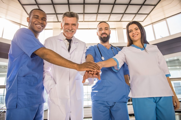 Doctors at the hospital clasped hands together as a team.