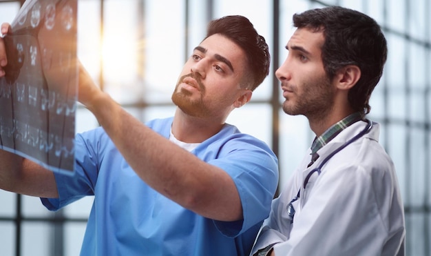 Doctors and an intern examine an Xray of a patient MRI scans of brain activity and scientists