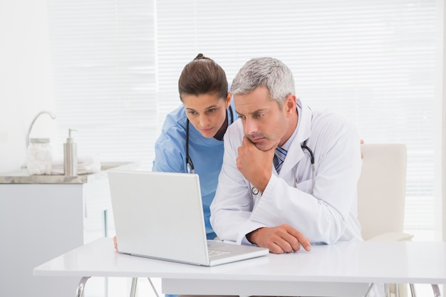 Doctors looking at laptop 