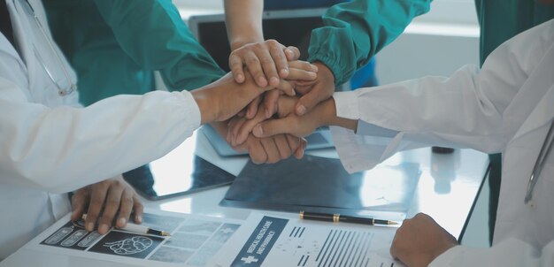 Doctors and nurses in a medical team stacking hands