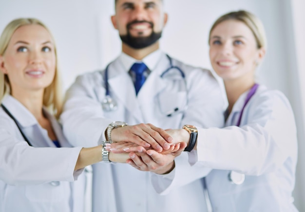 Doctors and nurses in a medical team stacking hands