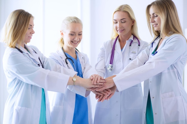 Doctors and nurses in a medical team stacking hands