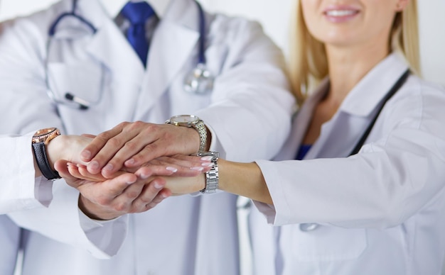 Doctors and nurses in a medical team stacking hands