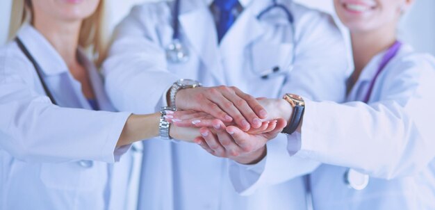 Doctors and nurses in a medical team stacking hands