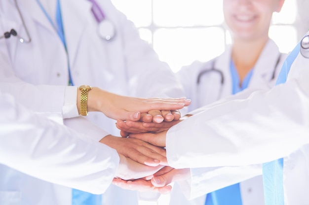 Doctors and nurses in a medical team stacking hands