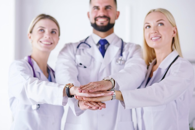 Doctors and nurses in a medical team stacking hands