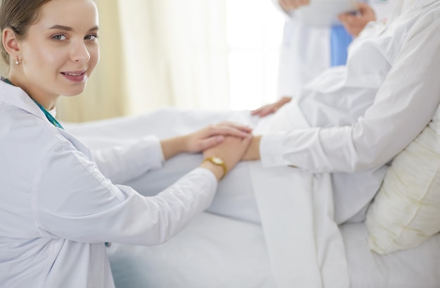 Doctors and nurses stacking hands Isolated on white