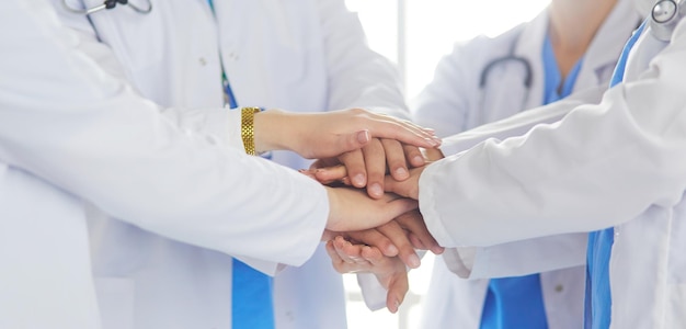 Doctors and nurses stacking hands Isolated on white