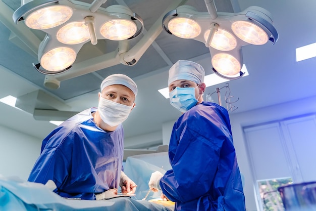 Doctors in operating room with neurosurgery equipment. Doctors are providing operation. Modern medical background