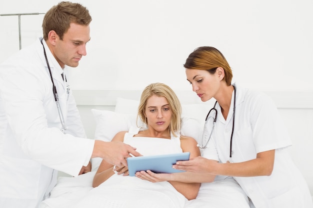 Doctors and patient with digital tablet in hospital