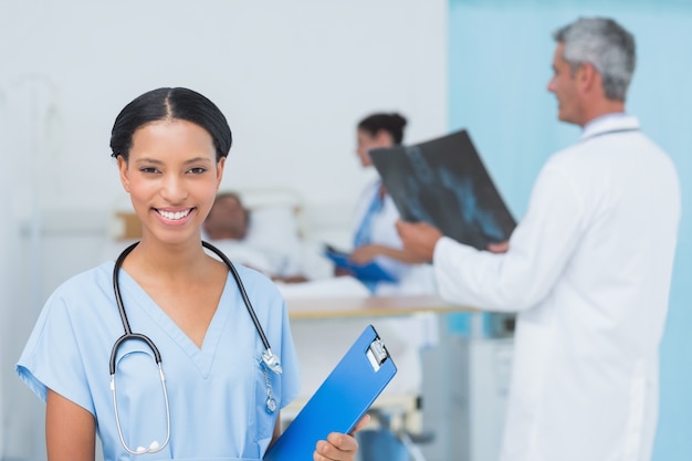 Photo doctors and patient with x-ray in hospital