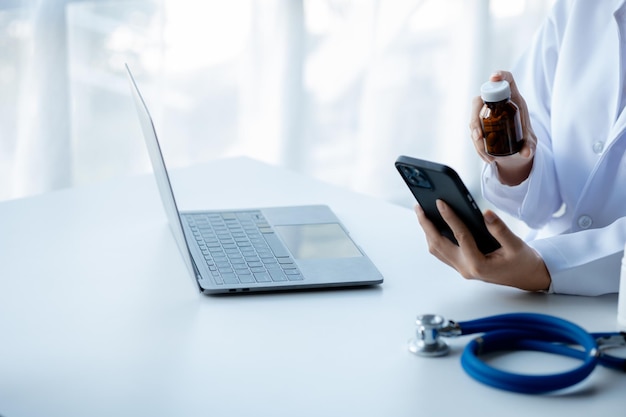 Doctors print reports on smartphones in the hospital's medical room treating diseases from specialists and providing targeted treatment Concepts of medical treatment and specialists