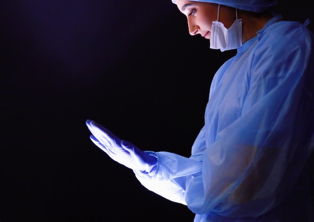 Doctors team in surgery in a dark background