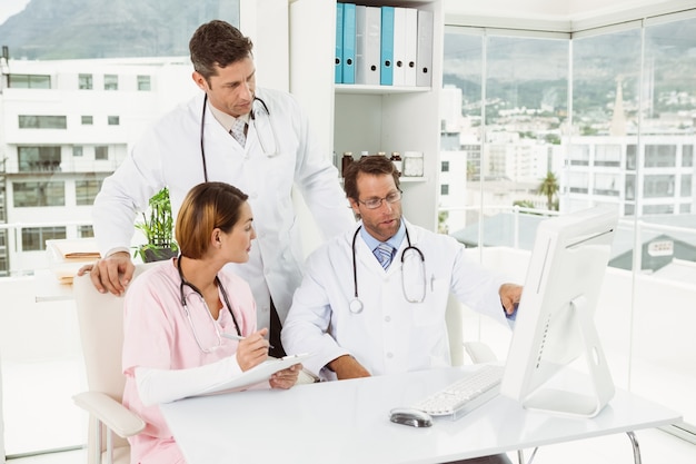 Doctors using computer at medical office