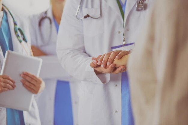 Doctors using a tablet in hospital standing in office