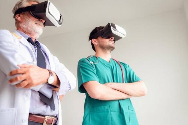 Doctors wearing virtual reality simulators while standing against wall