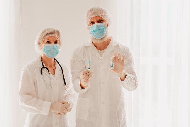 Doctors with face mask are ready to work with the vaccine against the covid-19 virus