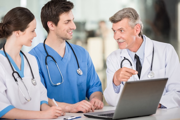 Doctors working together on a laptop at doctor's office.