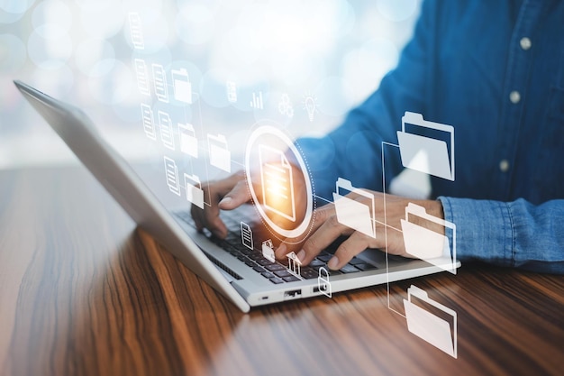 Document management concept businessman using computer to\
document management concept online documentation database and\
digital file storage system or software records keeping database\
technology