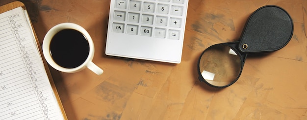 Photo document with calculator and magnifier on the working table