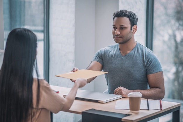 Documents check. Boss checking the documents and looking unsatisfied