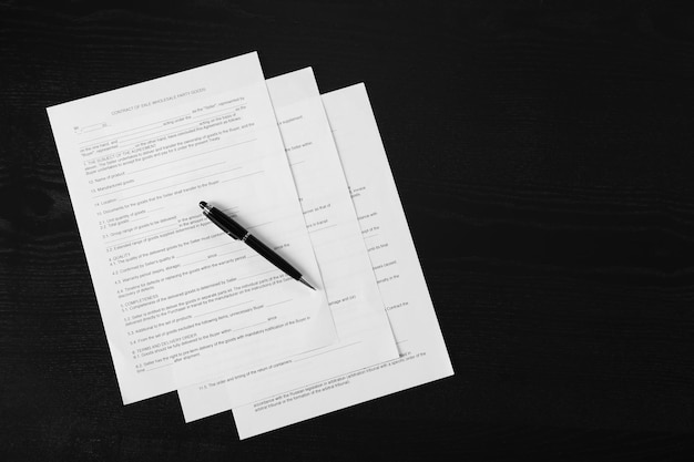 Photo documents and pen on wooden table top view