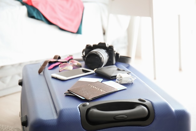 Documents and tourist's stuff on travel suitcase