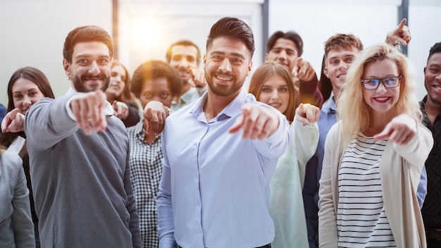 Doe mee met een succesvol team. Jonge mensen wijzen naar je.