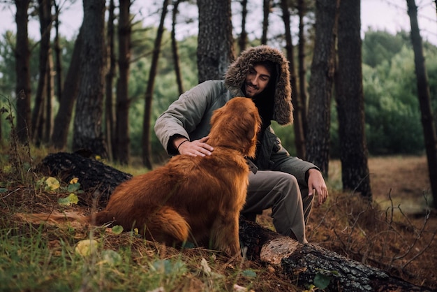 Dog on dirt road amidst trees in forest