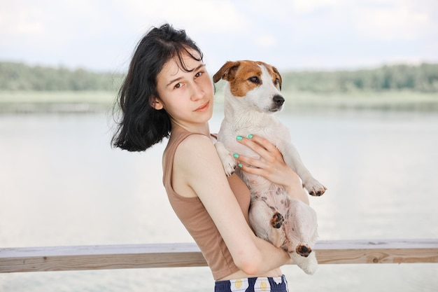 Dog Jack Russell Terrier plays with a girl