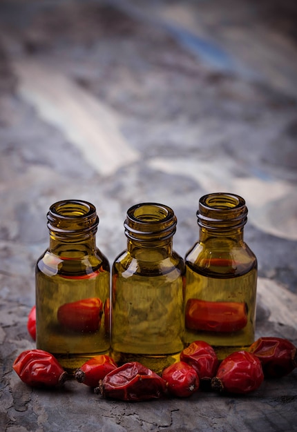 Dog rose essential oil on small bottles. Selective focus