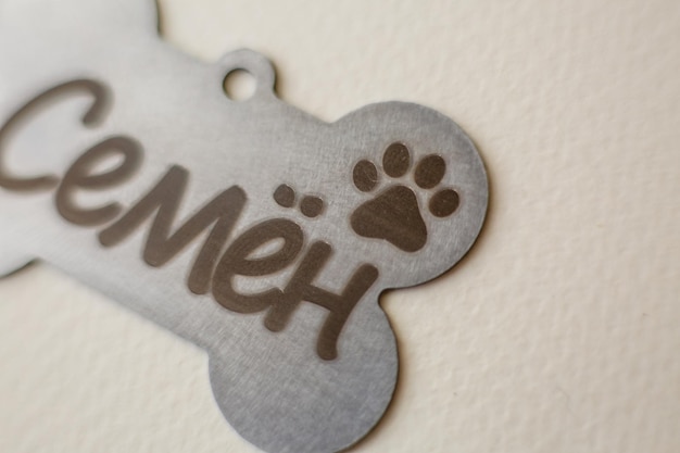 A dog tag with a paw print on it