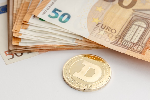 Dogecoin coin and Euro banknotes. Blockchain money versus fiat money concept