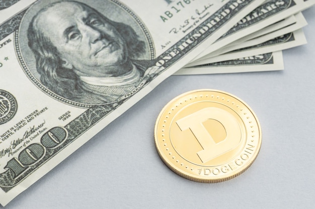 Dogecoin coin and a pile of US dollar banknotes. Blockchain money versus fiat money concept