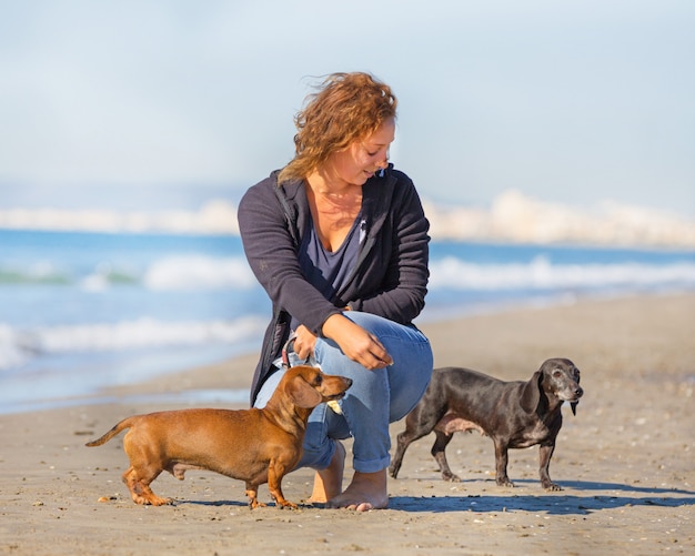 dogs and woman on the beach