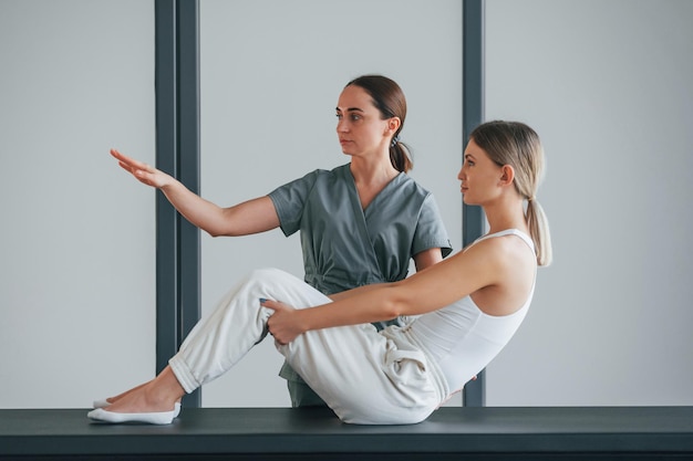 Doing abs woman is in health center getting help by doctor