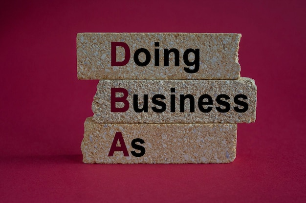 Doing Business As symbol Text Doing Business As on brick blocks Beautiful red background