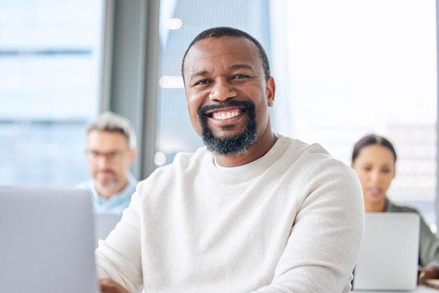 Doing business with utmost dedication Portrait of a mature businessman working on a laptop in an office