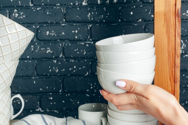 Doing cleaning up in a kitchen, woman and tableware